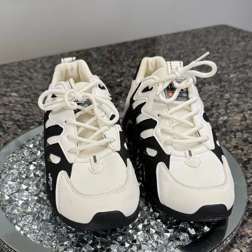 White and Black womens fashion Sneakers with gold accents EUC 10